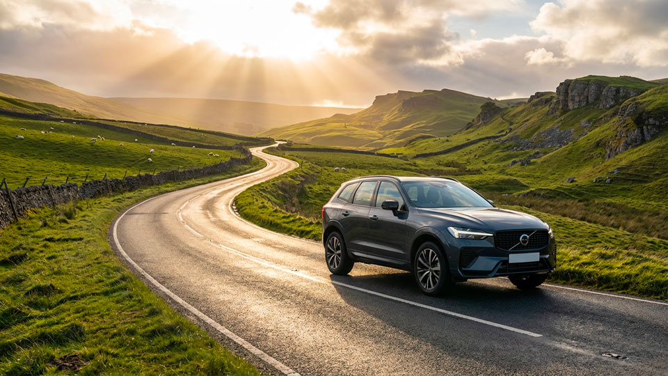 Volvo XC90 SUV driving through a Yorkshire Dales valley at sunset